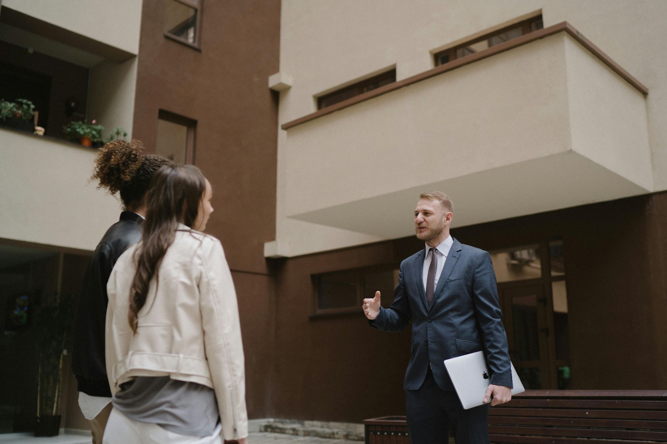 couple with agent; Melbourne brokers help property investors with investment loans.