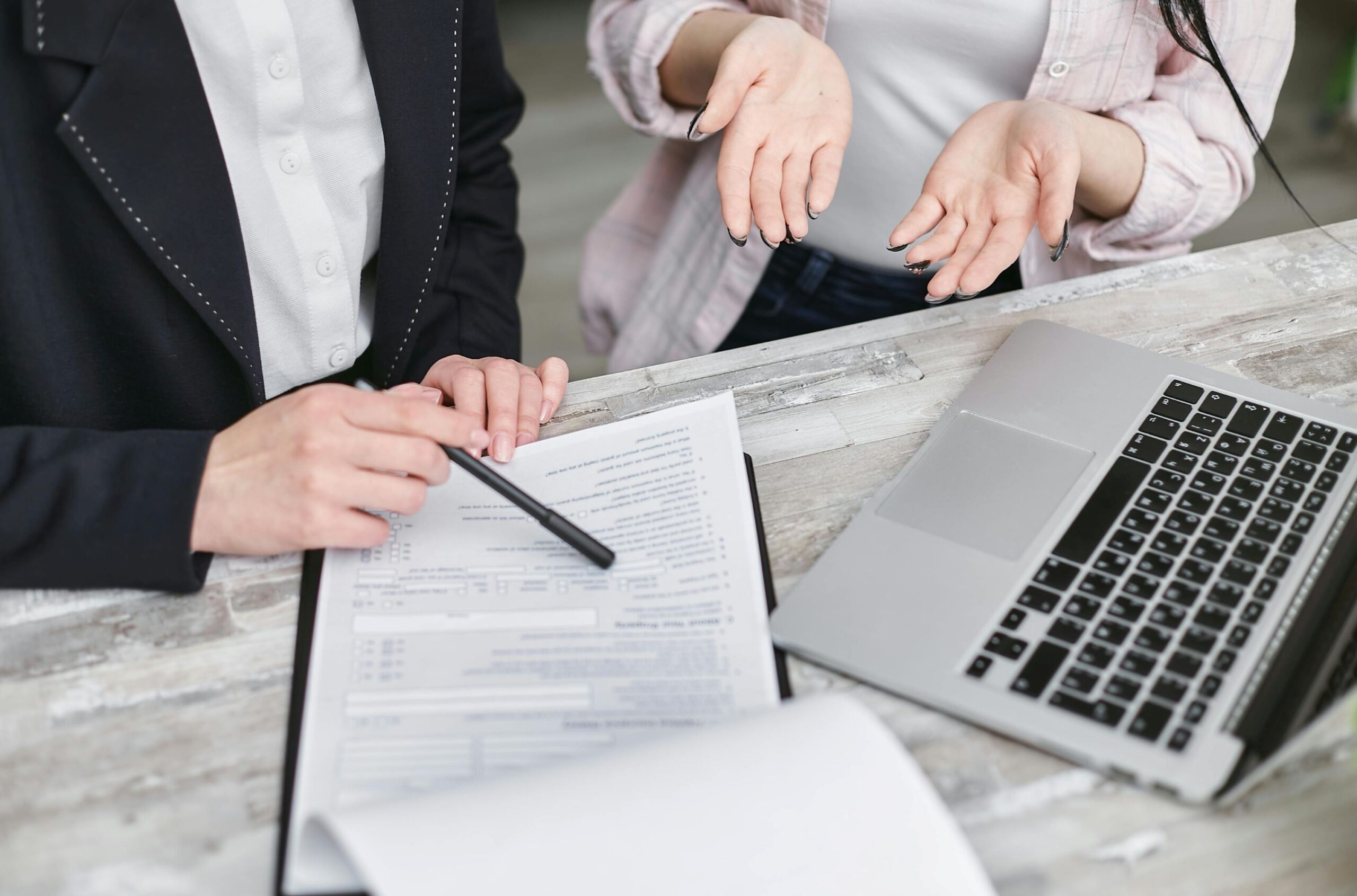 two people in discussion: Melbourne brokers help buyers with LMI process.