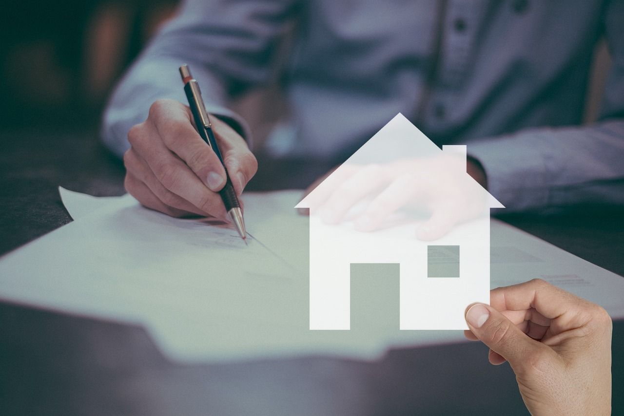 person writing on a mortgage document