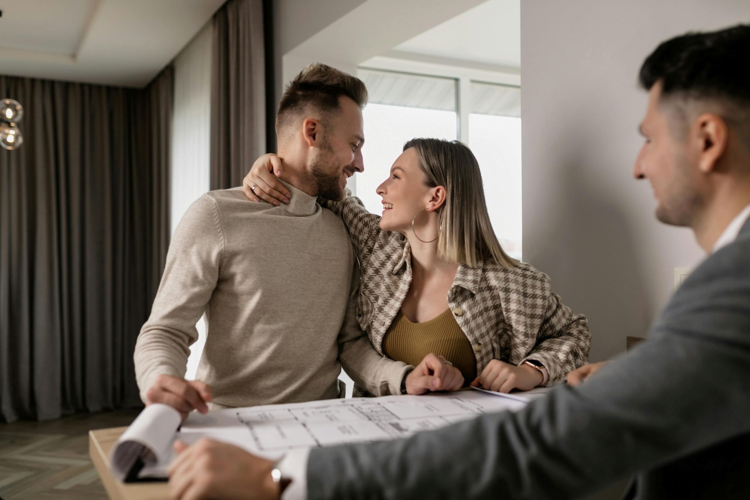 couple talking with a male real estate agent