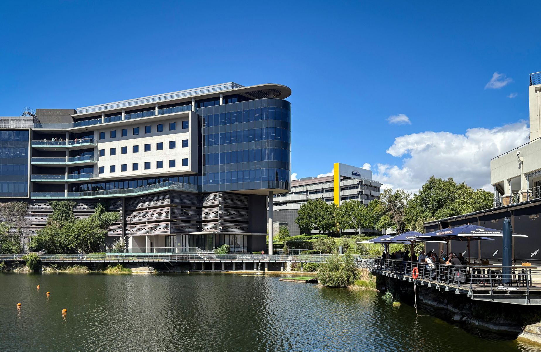 View of waterfront city scape with outdoor dining.