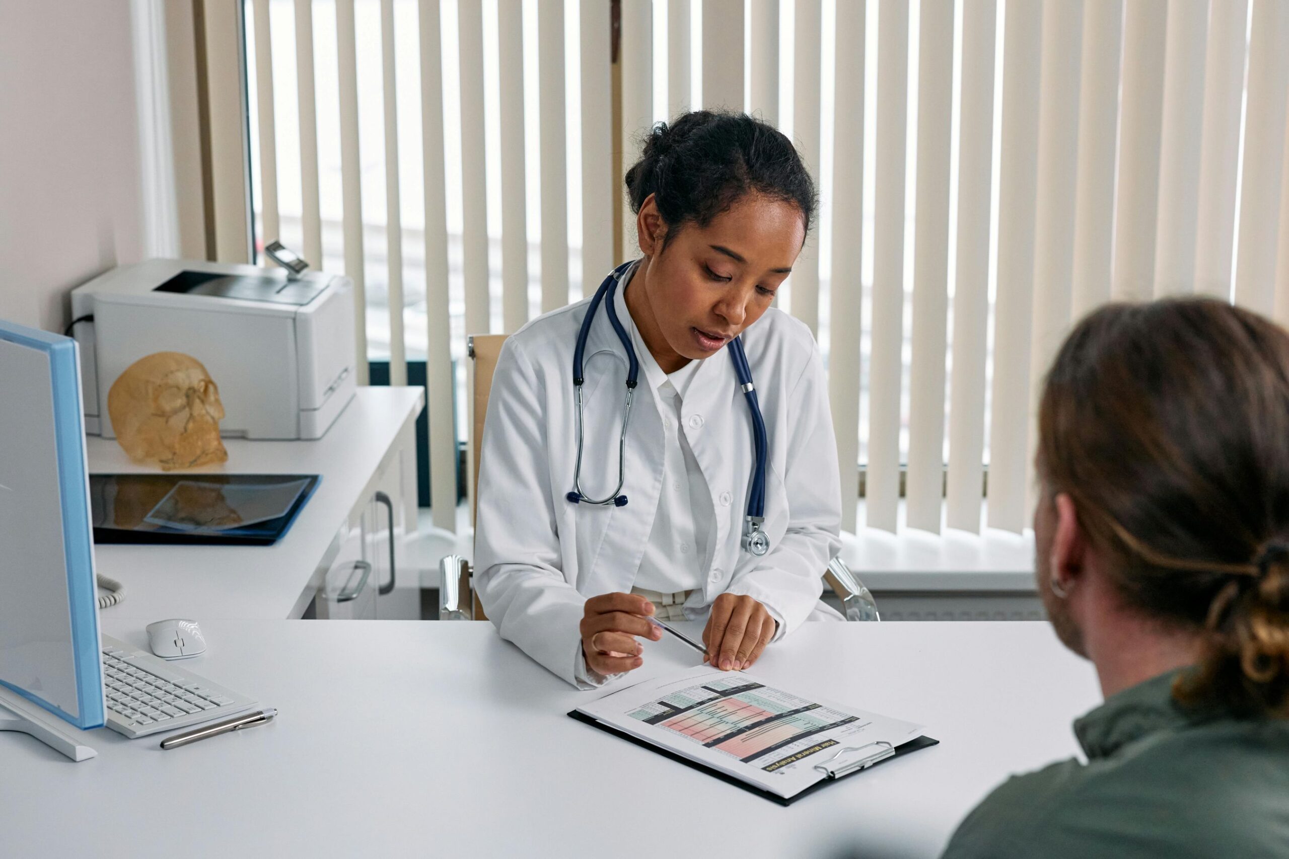A female doctor in consultation with a patient.