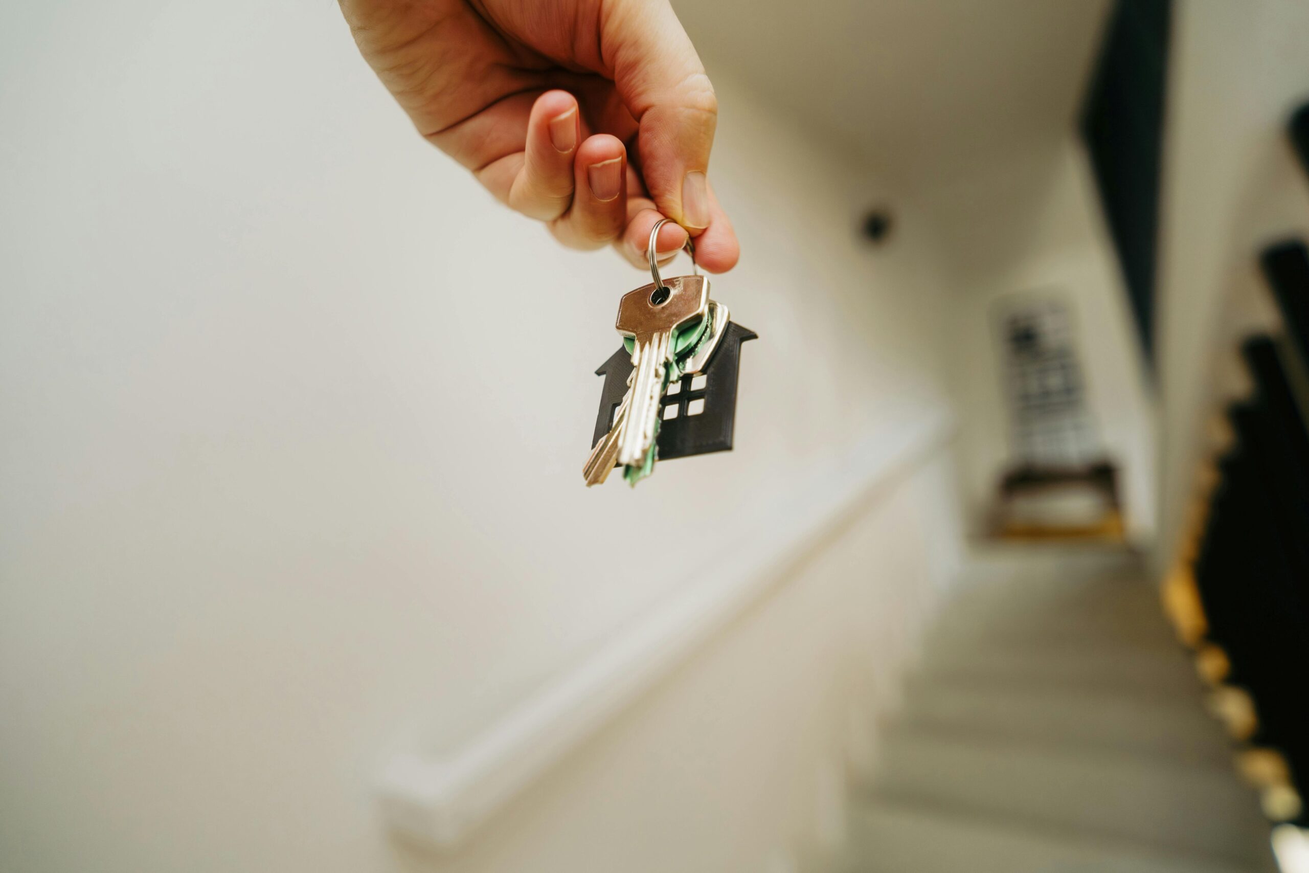A hand holding a house key.