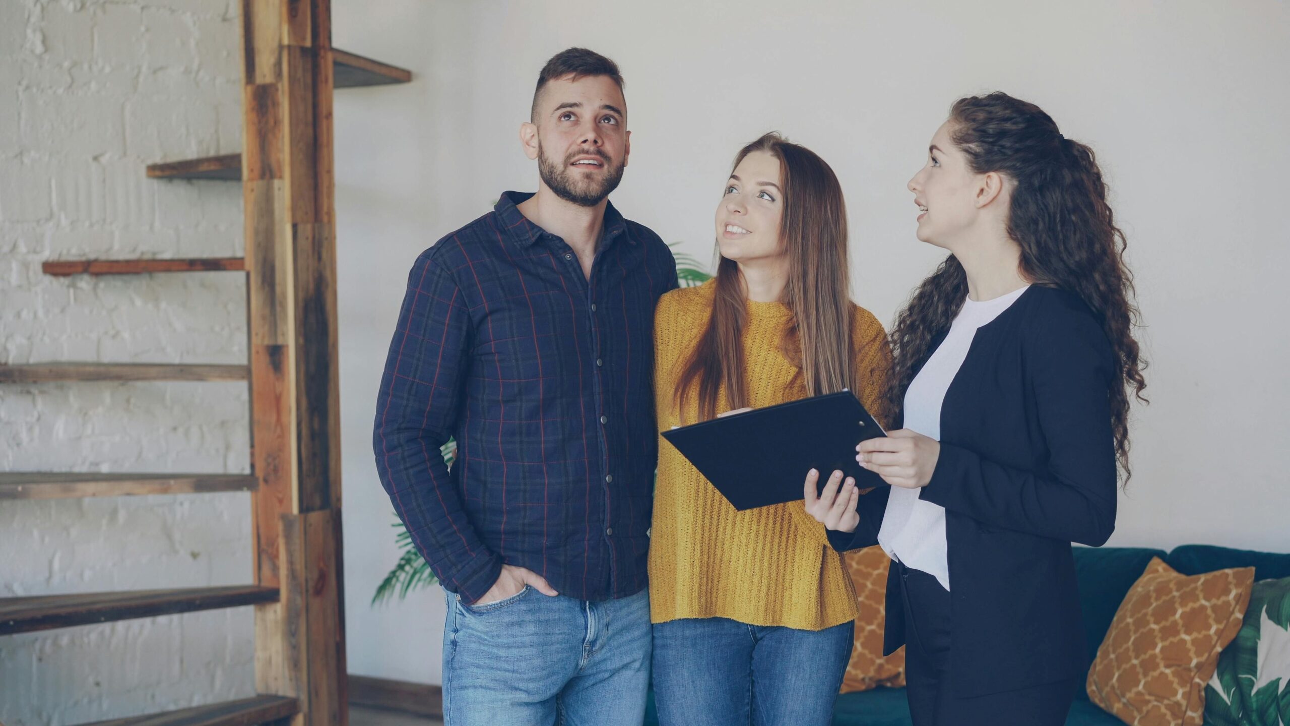 A couple checking a house with an agent.