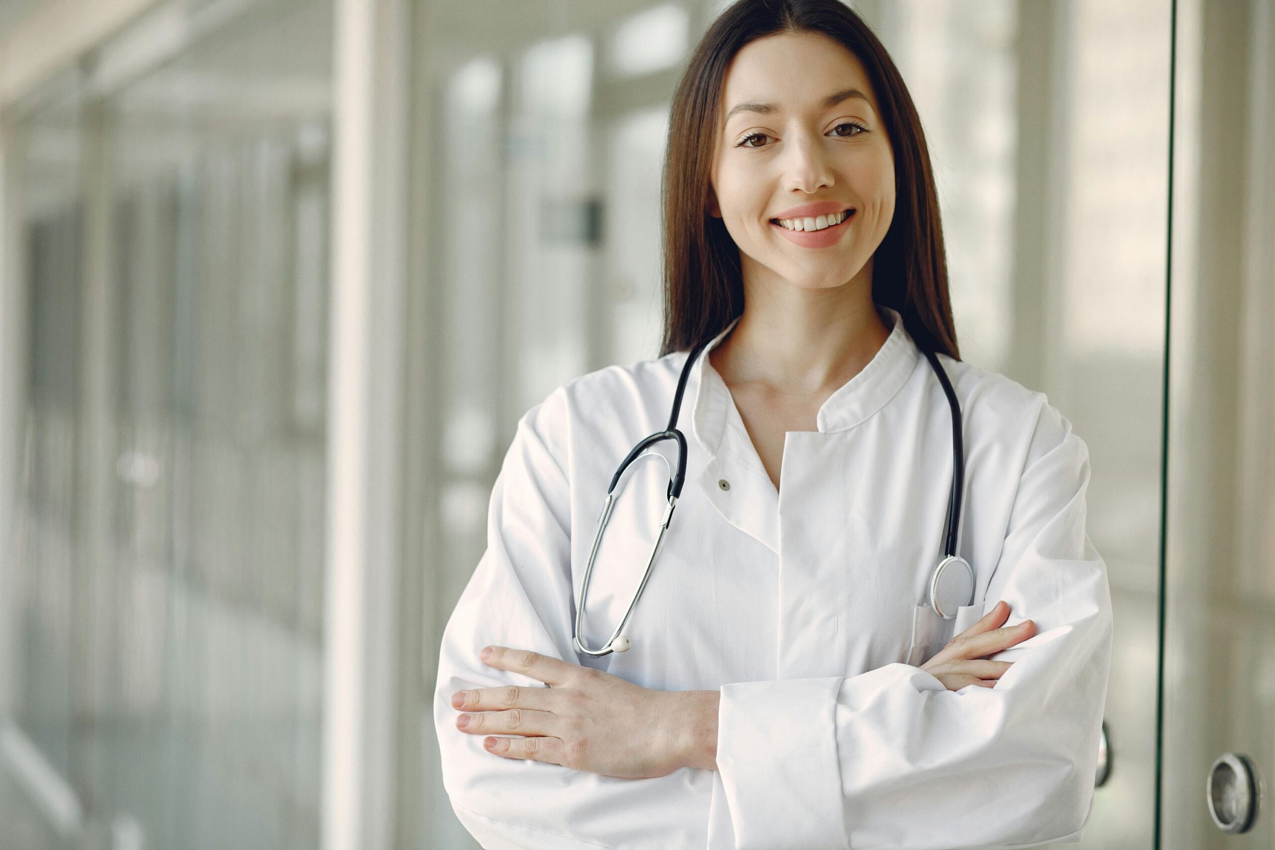Female doctor standing with stethoscope around her neck.