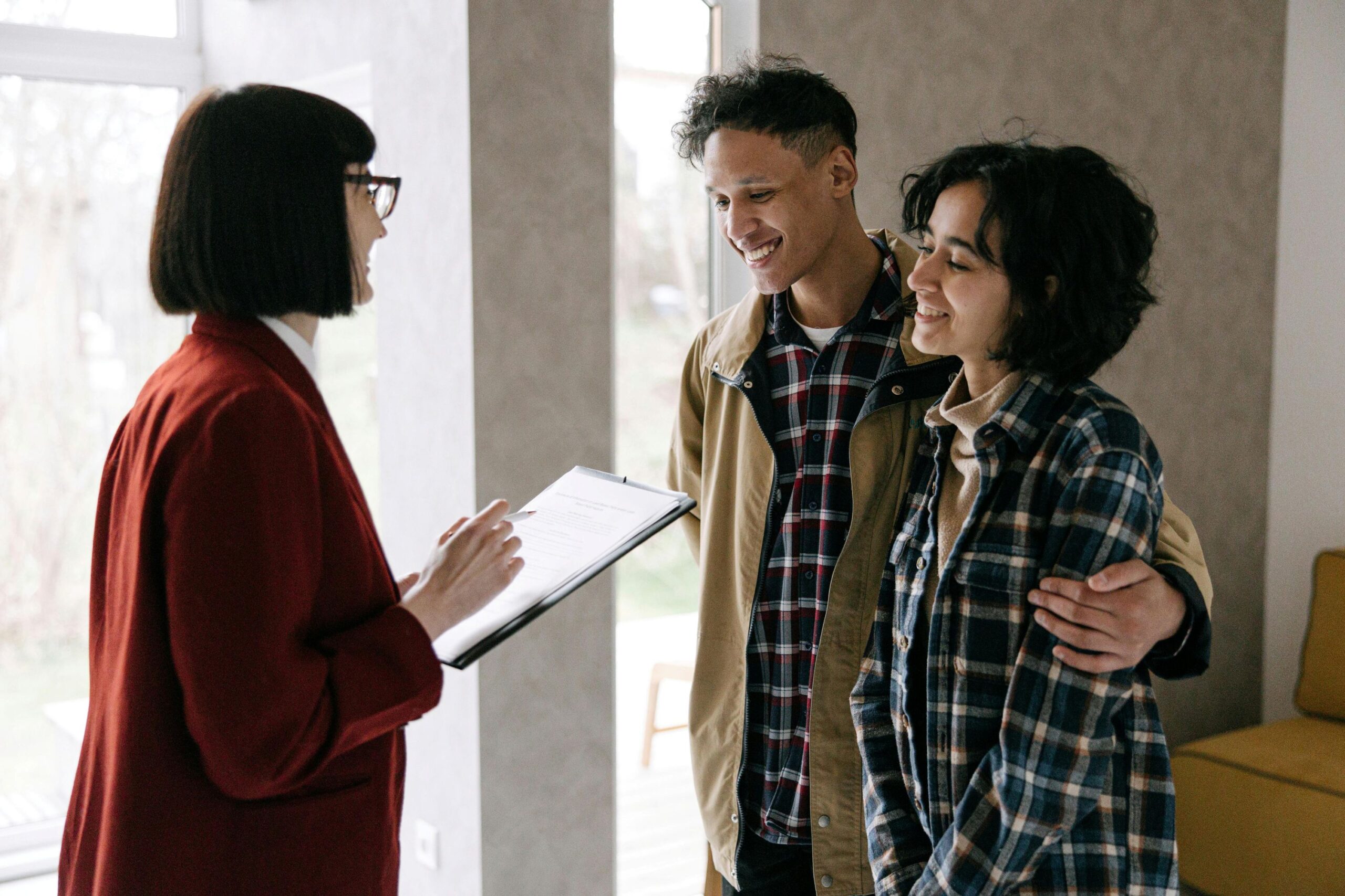 A couple talking with a female agent.