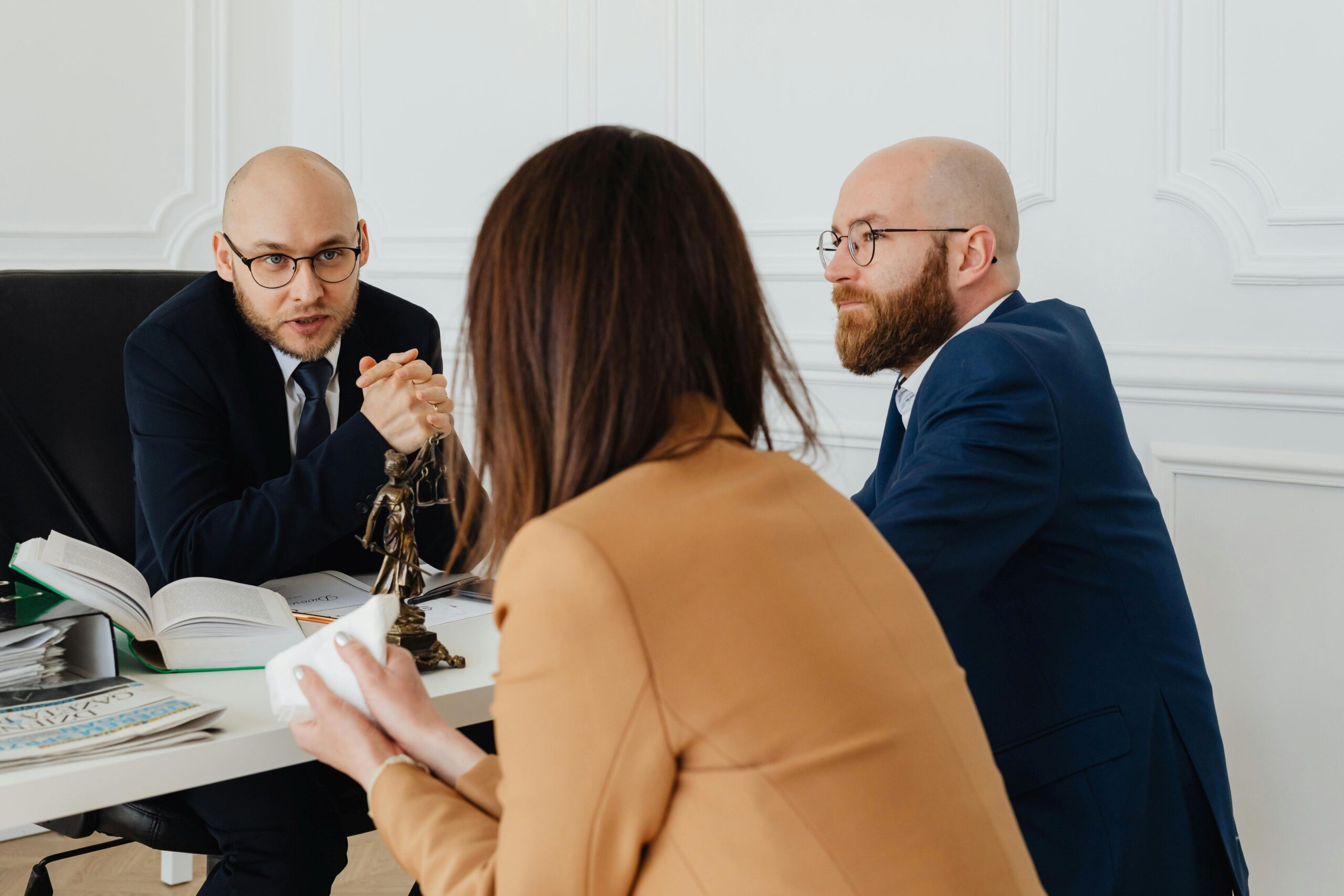 Male lawyer in conversation with clients.