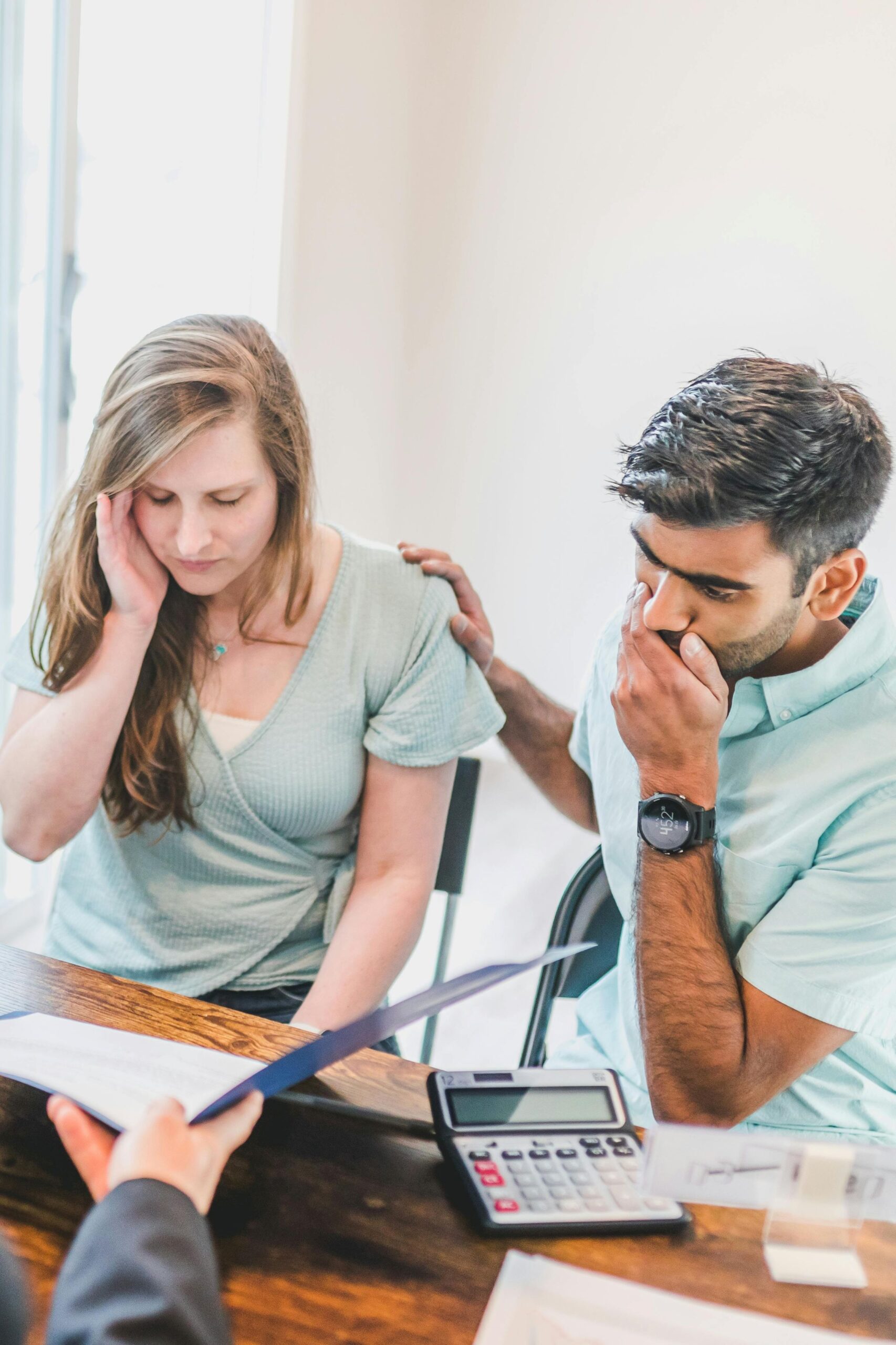 A couple in discussion with a broker.