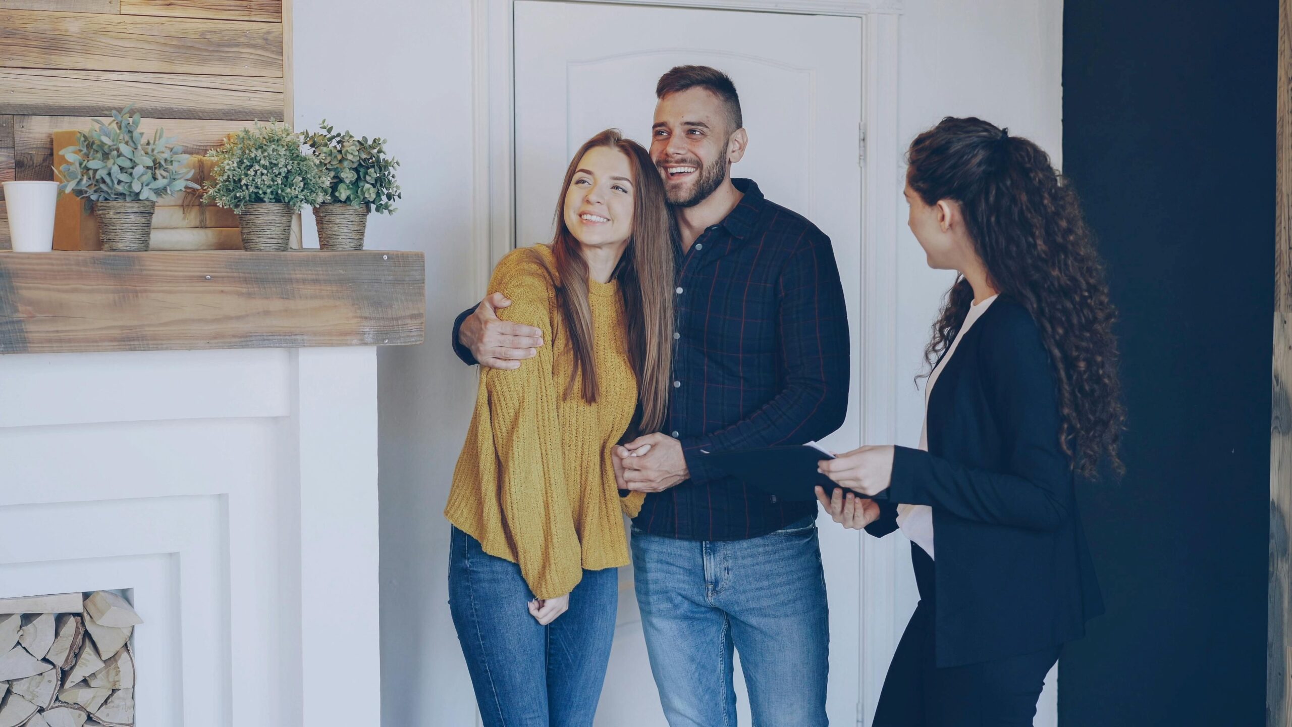 A couple checking a house with a female agent.