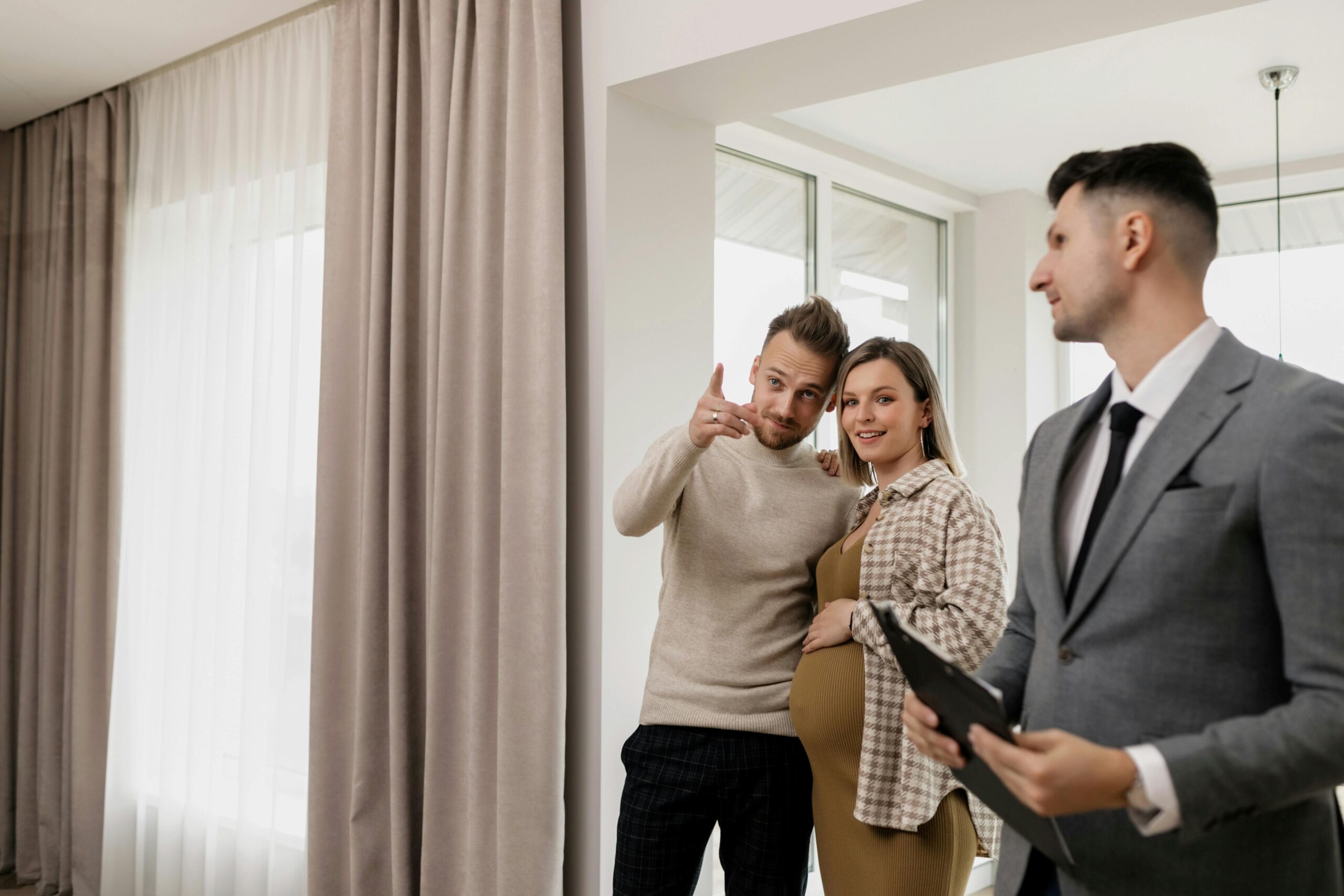 A couple checking a house with a male agent.