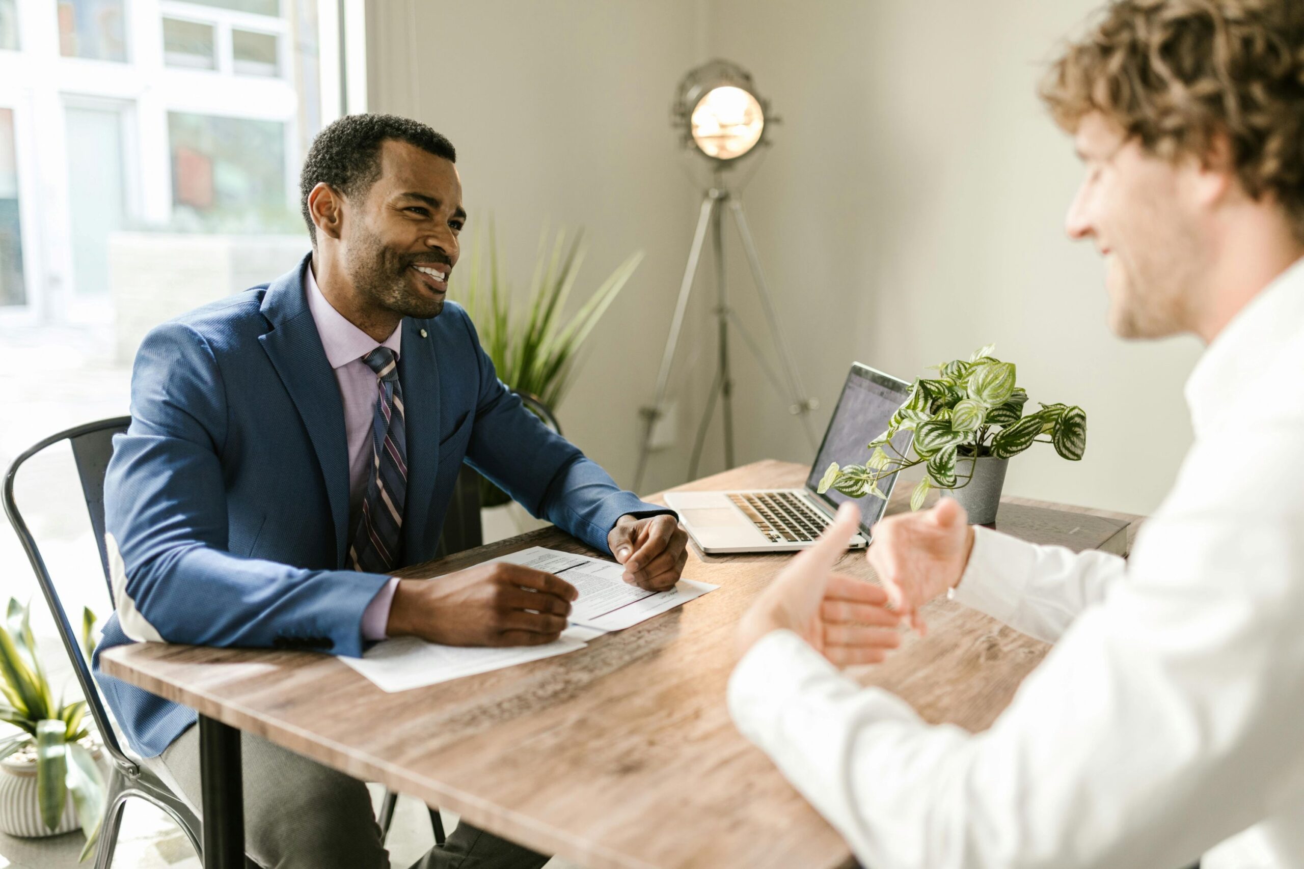 A smiling agent talking with client.