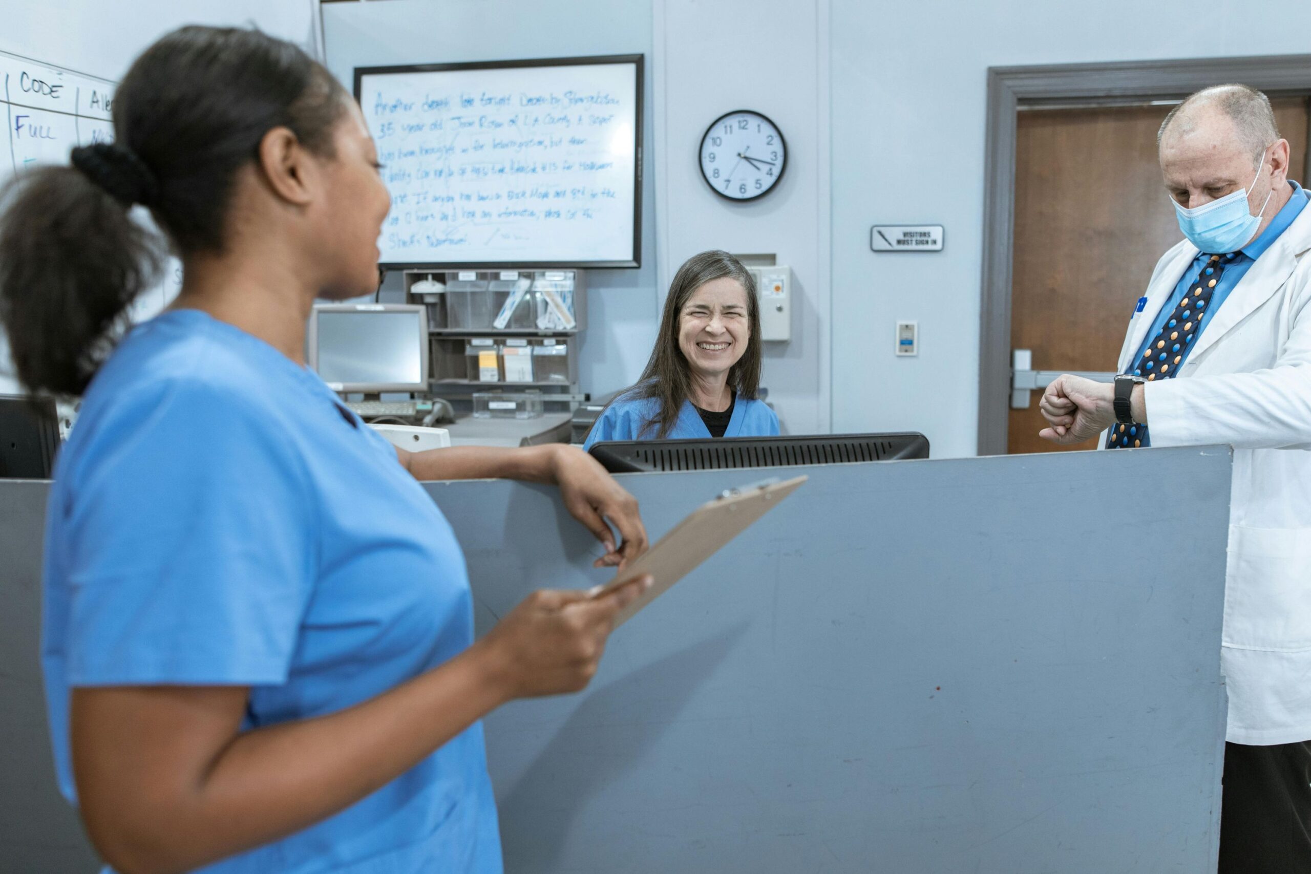 Female nurses chatting at a counter.