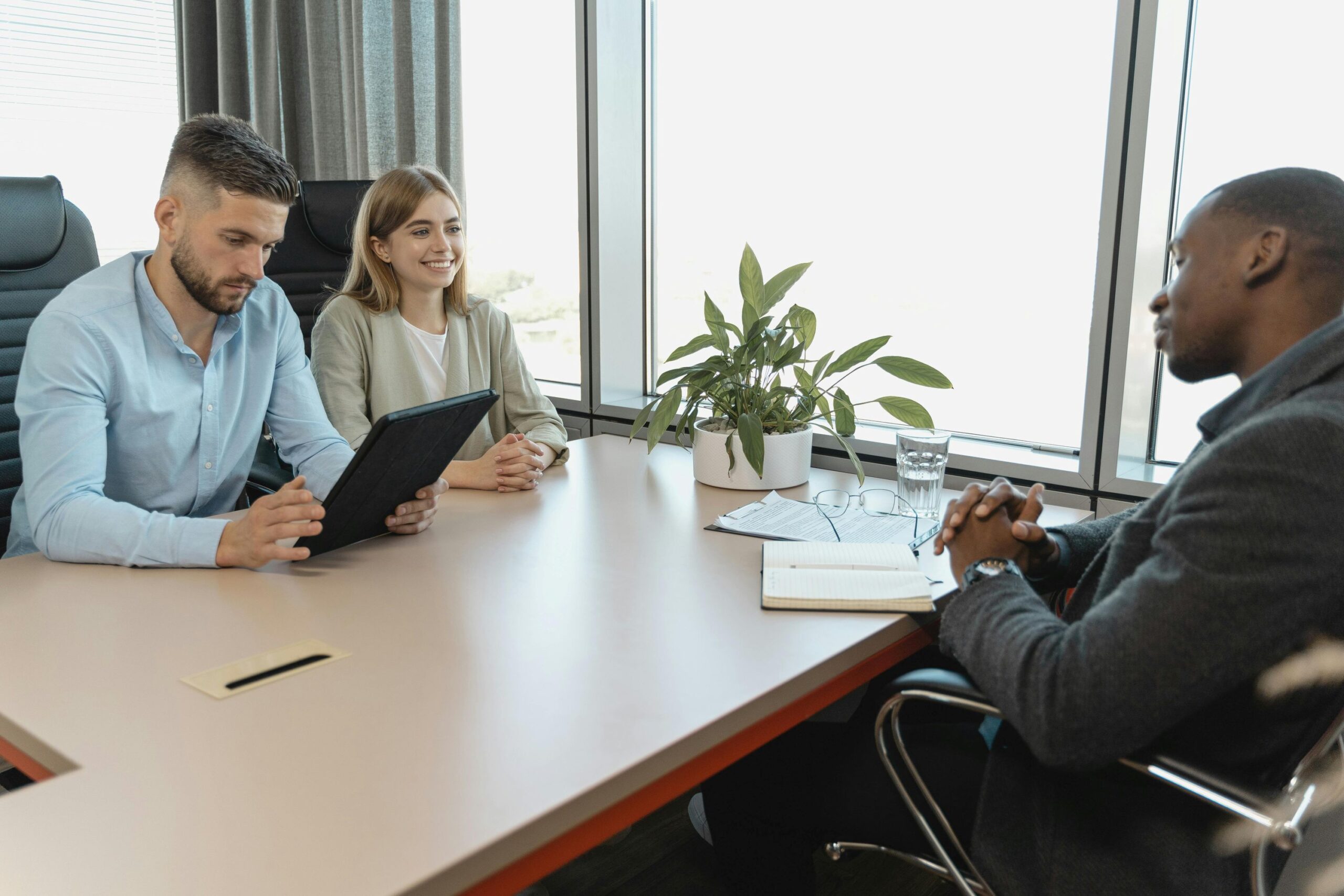 A couple discussing with male client.
